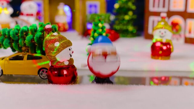Against the backdrop of a small Christmas town, an unusual Santa Claus jumps up to a snowman and a yellow car