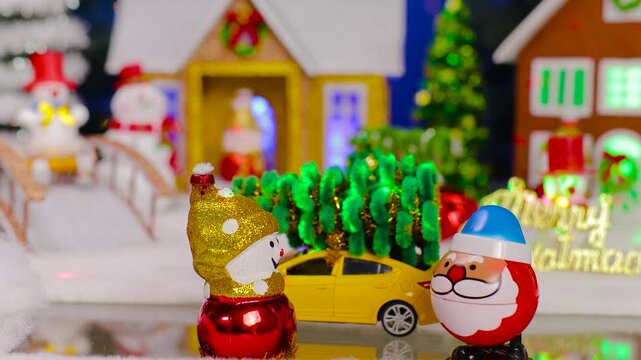 Against the backdrop of a small Christmas village, an unusual Santa Claus jumps up to a snowman and a yellow car