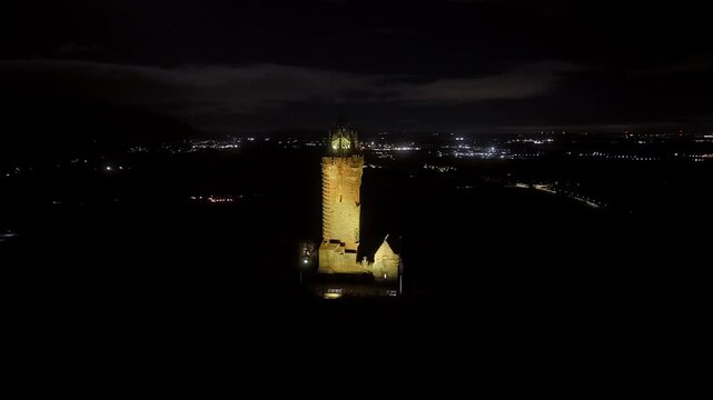 Beautiful Cinematic NIGHT aerial view of the National Wallace Monument Aerial View Over Stirling, Scotland &ndash; Historic Landmark and Scenic Town Landscape
