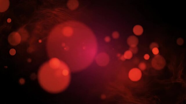 Red and orange glowing bokeh lights on dark background.
