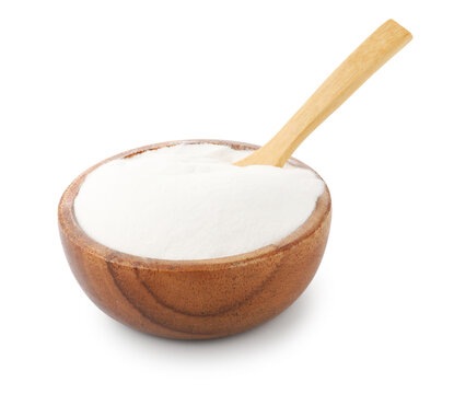Baking soda and spoon in wooden bowl isolated on white