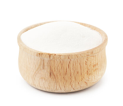 Baking soda in wooden bowl isolated on white