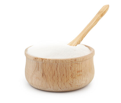 Baking soda and spoon in wooden bowl isolated on white
