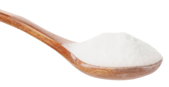 Baking soda in wooden bowl isolated on white