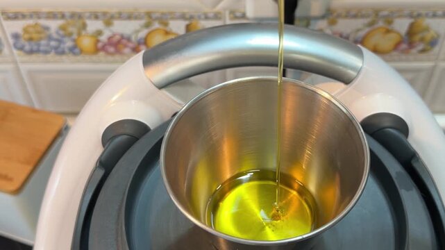 Enjoying the art of making salmorejo with olive oil in a cozy kitchen setting