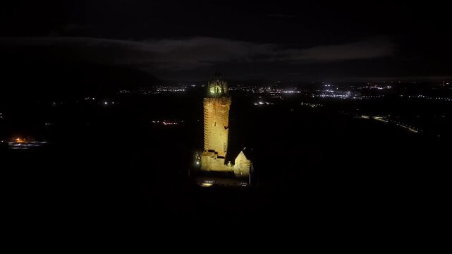 Beautiful Cinematic NIGHT aerial view of the National Wallace Monument Aerial View Over Stirling, Scotland &ndash; Historic Landmark and Scenic Town Landscape