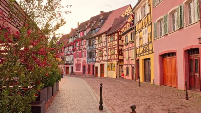 Iconic static perspective of half-timbered house reflections on still Colmar canal water
