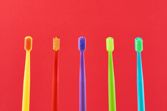 Colorful toothbrushes lining up, displaying vibrancy and promoting daily dental hygiene and oral health