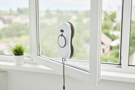 Automatic window cleaning robot washing glass in high-rise building, providing convenience and efficiency for modern home maintenance