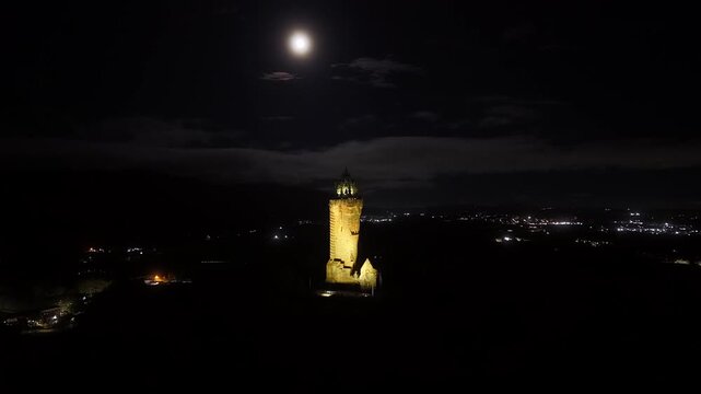 Beautiful Cinematic NIGHT aerial view of the National Wallace Monument Aerial View Over Stirling, Scotland &ndash; Historic Landmark and Scenic Town Landscape
