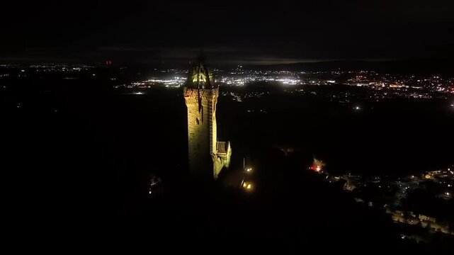 Beautiful Cinematic NIGHT aerial view of the National Wallace Monument Aerial View Over Stirling, Scotland &ndash; Historic Landmark and Scenic Town Landscape