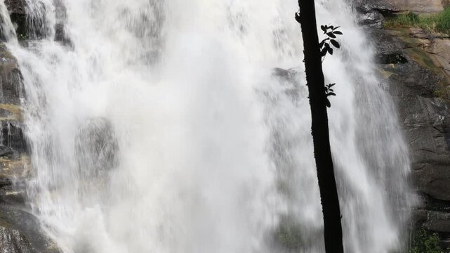 The video features a stunning natural backdrop of a waterfall in Chiang Mai, located on the summit of Doi Inthanon, a popular destination for travelers from around the world.