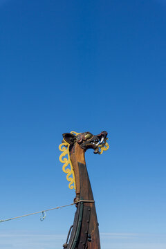Viking ship dragon head carving against Oslo blue sky