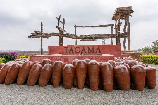 Ica, Peru, July 04, 2026: Historic wooden wine press and traditional clay vessels at Tacama vineyard in Ica, Peru, representing winemaking heritage and wine tourism.