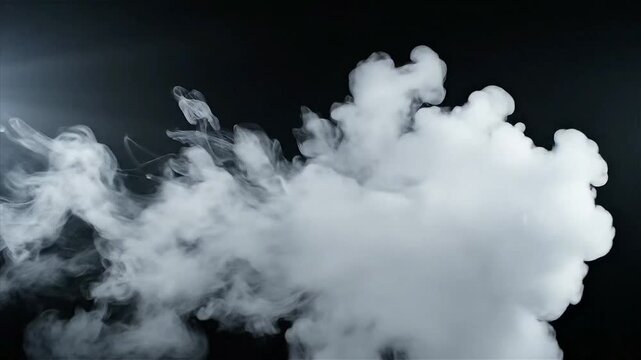 Abstract white smoke cloud swirling dynamically against a dark black background ideal for visual overlay and texture effects