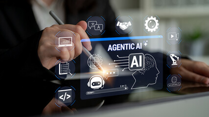 Obraz premium Business Professional Using Digital Interface to Explore Concept of Agentic AI Technologies and Applications for Future Innovation and Automation. Glyphic.
