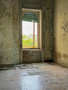 Abandoned historic room with window and natural daylight interior