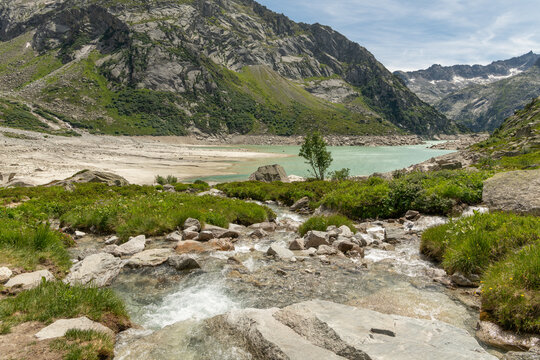 Guttannen, Switzerland. Crystal-clear alpine stream flowing into Gelmersee reservoir in the Bernese Alps