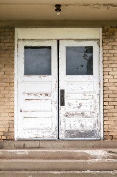 Old White Double Doors at Top of Concrete Stairs