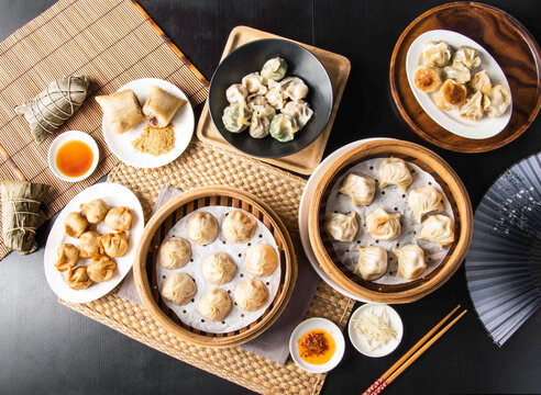 Assorted Chinese dim sum feast. Traditional steamed dumplings served in bamboo steamers.