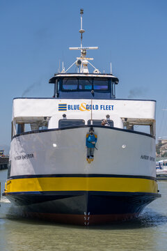 San Francisco, CA - July 15 2026: The Harbor Emperor ferry of the Blue and Gold Fleet awaits passengers at a busy waterfront berth at Pier 39.