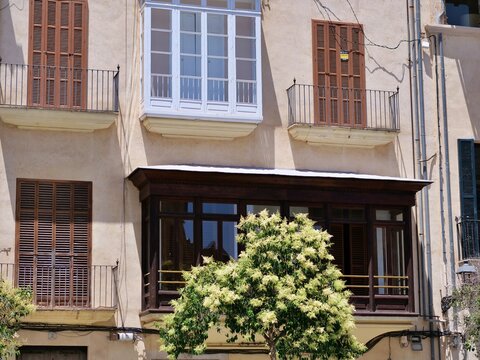 Traditional Mediterranean Building Facade with Wooden Bay Windows