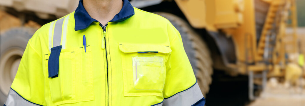 Worker wearing high visibility jacket with pen in pocket