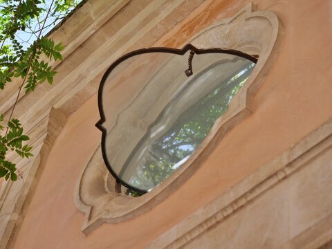 Unique Quatrefoil Window Frame on Warm Plaster Wall