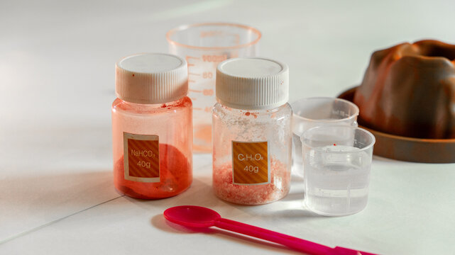 Chemical reagents in a jar for a children's chemical experiment in a volcano. Effervescent reaction of soda and citric acid and water. Children's toy, experiment, education.