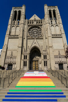 The majestic stone facade of Grace Cathedral towers above the iconic rainbow stairs in the historic Nob Hill neighborhood of San Francisco California.