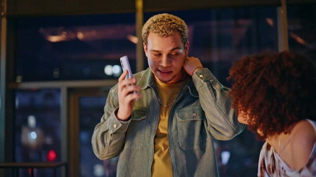 Man phone call shocked reaction with woman. Friends amazed good news evening.