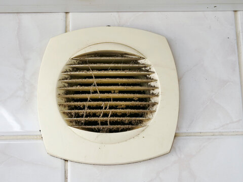 Dirty air vent with dust and cobwebs. Ventilation system needs cleaning. Grates covered in debris and filth. Dusty and neglected home or building feature. Not clean or maintained