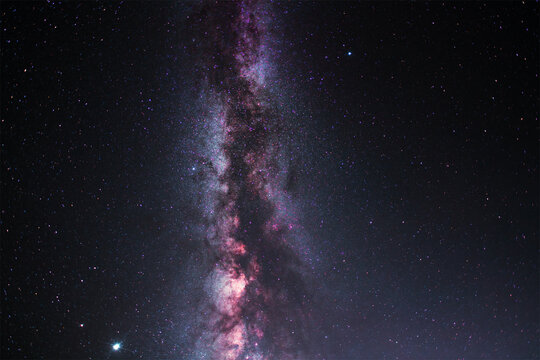 Colorful bright Milky Way galaxy on the starry sky.