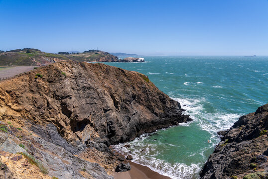 Dramatic cliffs enclose the secluded sandy shoreline of Hawk Tail Beach located within the scenic Marin Headlands of coastal Northern California.