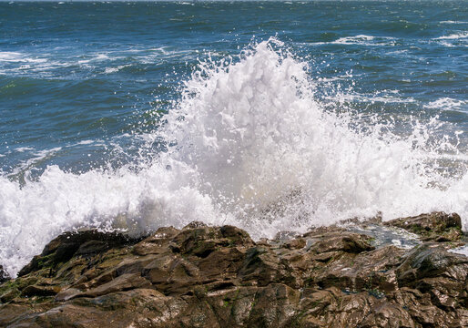 Frozen motion Pacific Ocean surf crashes against the rugged volcanic rock formations at Rodeo Beach within the scenic Marin Headlands of California.