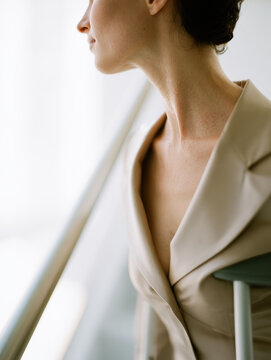 Shoulder crutch blazer neck skin office stairwell window light portrait
