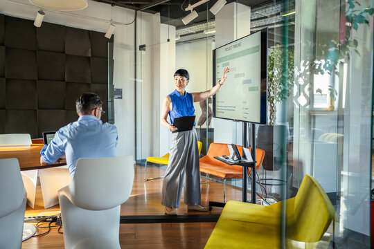 Businesswoman presenting project timeline during corporate meeting