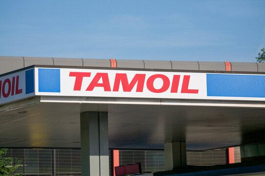 Tamoil gas station canopy logo sign under blue sky in Balerna, Switzerland