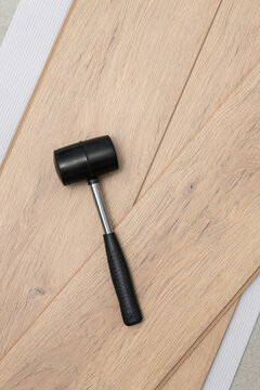 Rubber mallet tool on laminate boards with copy space