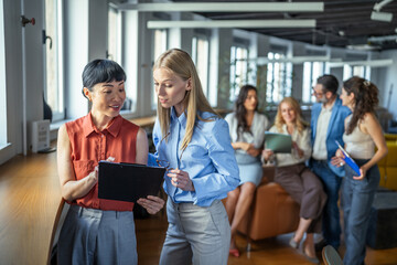 Fototapeta premium Businesswomen collaborating on presentation in modern office