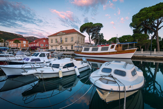 Boats and historic town hall in Jelsa harbor at sunset, Hvar island