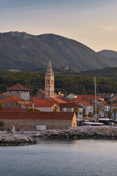 Historic church tower and stone houses of Jelsa town at sunset, Hvar Island, Croatia