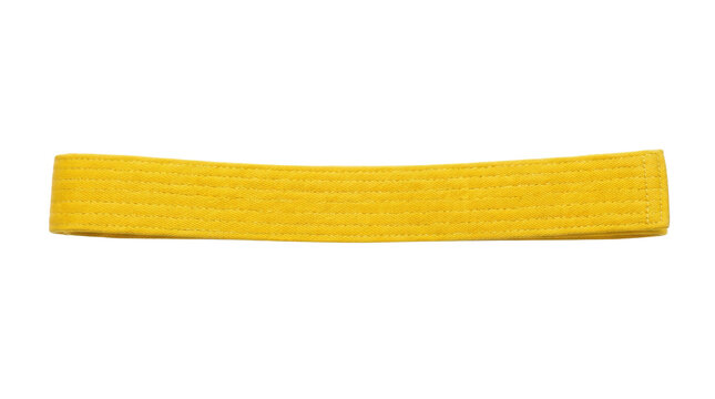 Bright yellow karate belt on black background for martial arts enthusiasts