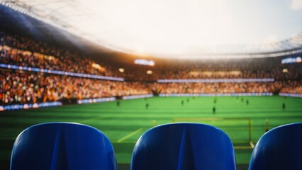 Close up of blue stadium seats in foreground and blurred soccer field with players and fans in background, highlighting empty live sports venue tribunes during football match. © DC Studio