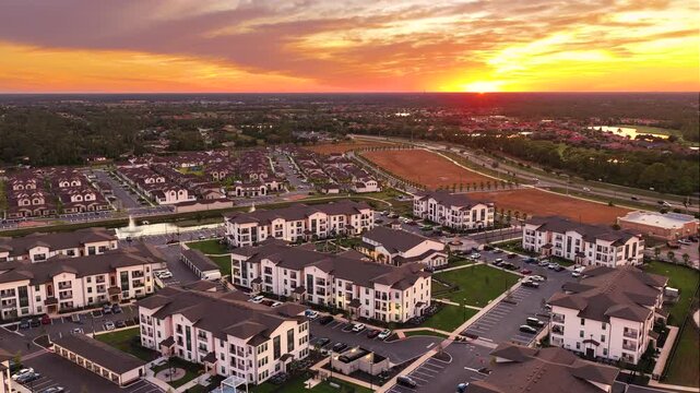Suburban Florida residential complex at sunset. Modern condominiums and landscaped surroundings. American housing trends concept.