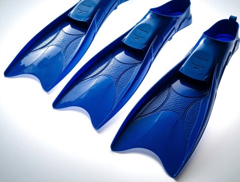 Three blue plastic fins arranged on clean white background. Modern glossy swimming equipment for scuba diving snorkeling sport activities. Durable flippers with ergonomic design provide pro speed,