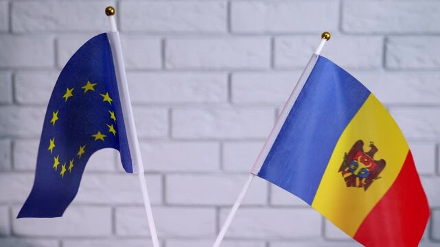 Moldova and the European Union. European union and republic of moldova flags flying together, symbolizing international cooperation, diplomatic relations, and the path of moldova's accession to the eu