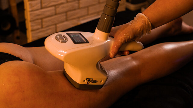 Apparatus massage. Vacuum roller massage. Anti-cellulite foot massage. Dim atmospheric warm light. self-care, care, weight loss