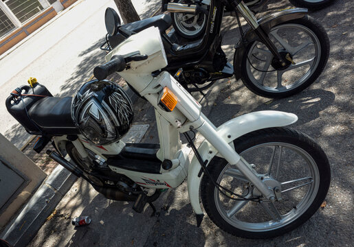 TAVERNES BLANQUES, SPAIN - JUNE 14, 2026.Classic white Vespino NL vintage moped parked on street with helmet attached during retro vehicle display in Spain