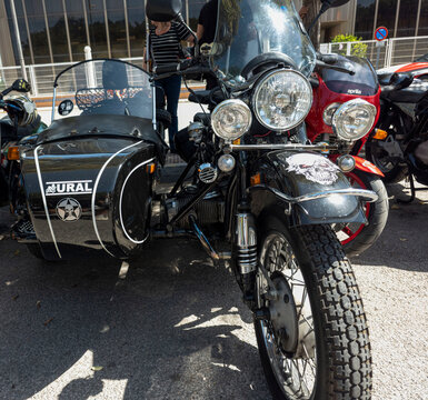 TAVERNES BLANQUES, SPAIN - JUNE 14, 2026.Black vintage Ural sidecar motorcycle and red Aprilia at outdoor bike show in Spain